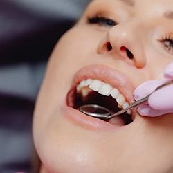 Close up of dentist examining woman’s mouth